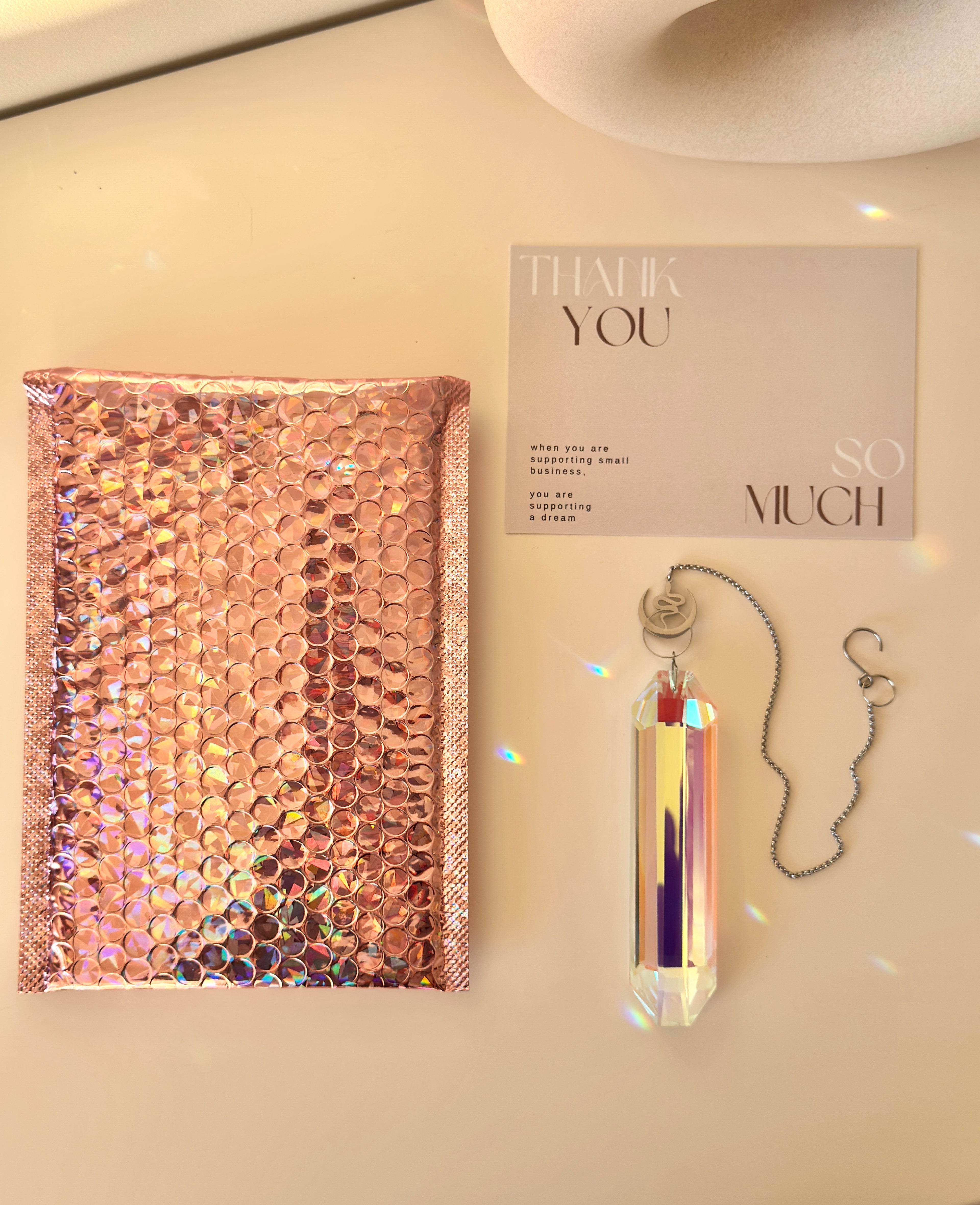 Alchemist's Shadow celestial suncatcher (Sonnenfänger) with a silver snake and moon charm, featuring a 12cm Aurora crystal casting rainbows (Regenbogen).