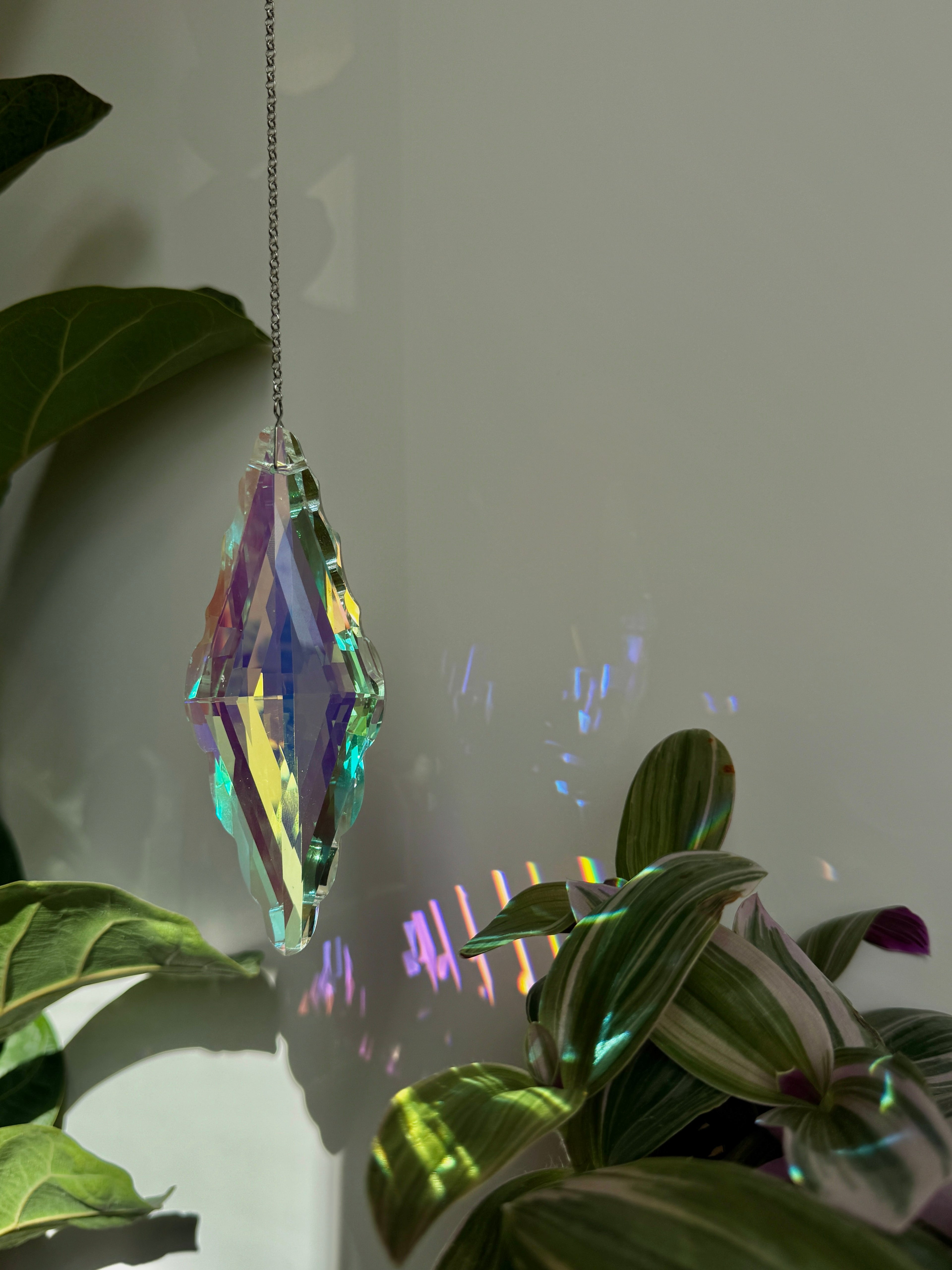 Large Aurora Pendulum suncatcher (Sonnenfänger) with a 12cm faceted crystal and silver chain, reflecting a spectrum of colors and rainbows (Regenbogen).