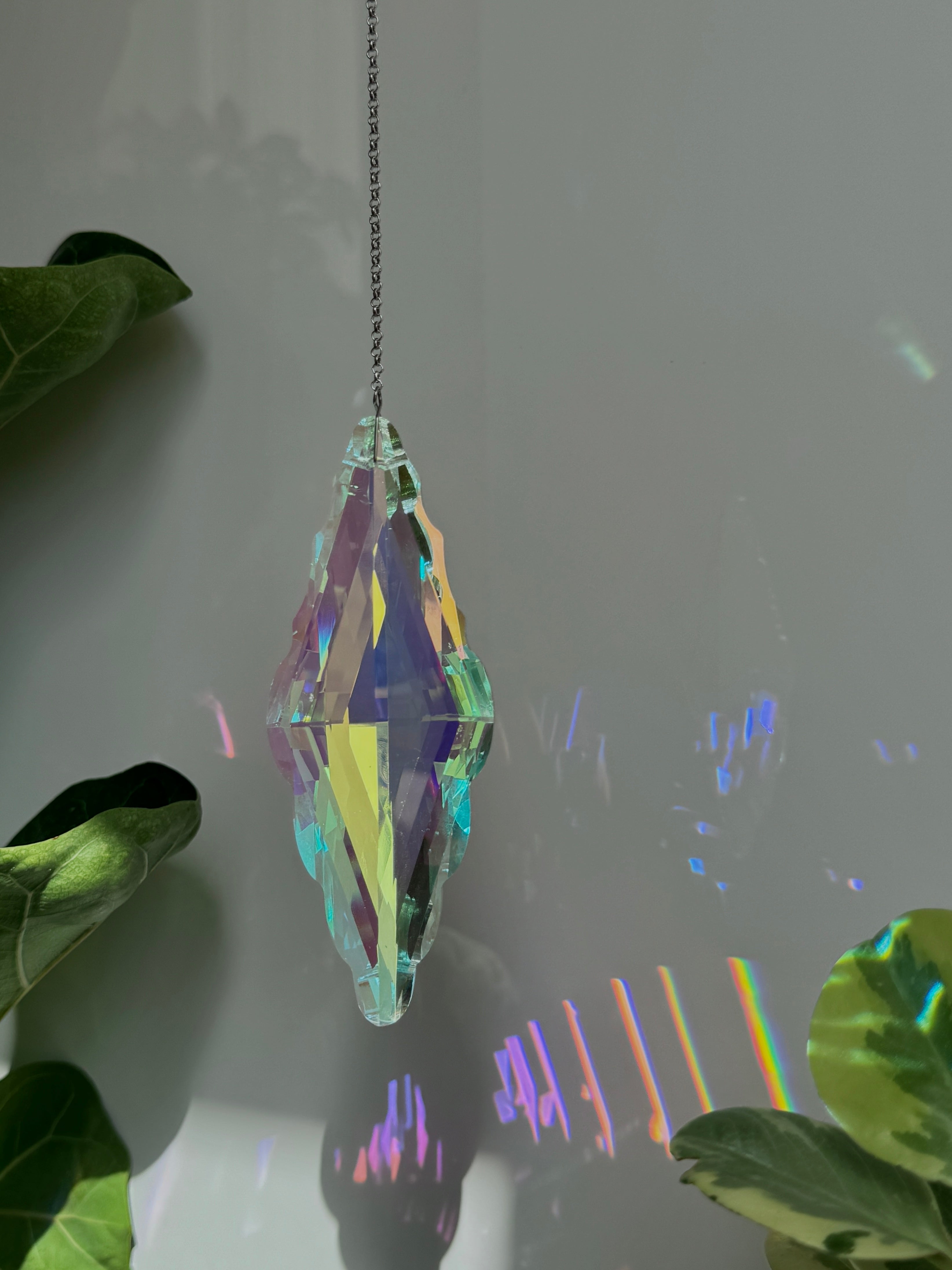 Large Aurora Pendulum suncatcher (Sonnenfänger) with a 12cm faceted crystal and silver chain, reflecting a spectrum of colors and rainbows (Regenbogen).