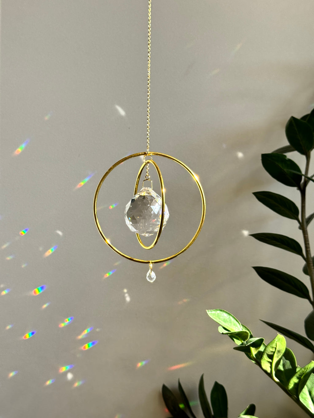 Gold Orbit suncatcher with a 40mm Asfour crystal prism. Minimalistischer Sonnenfänger for home decor casting rainbow light and beautiful Lichtreflexe on the wall. Boho-Stil window decoration and Regenbogenmacher.