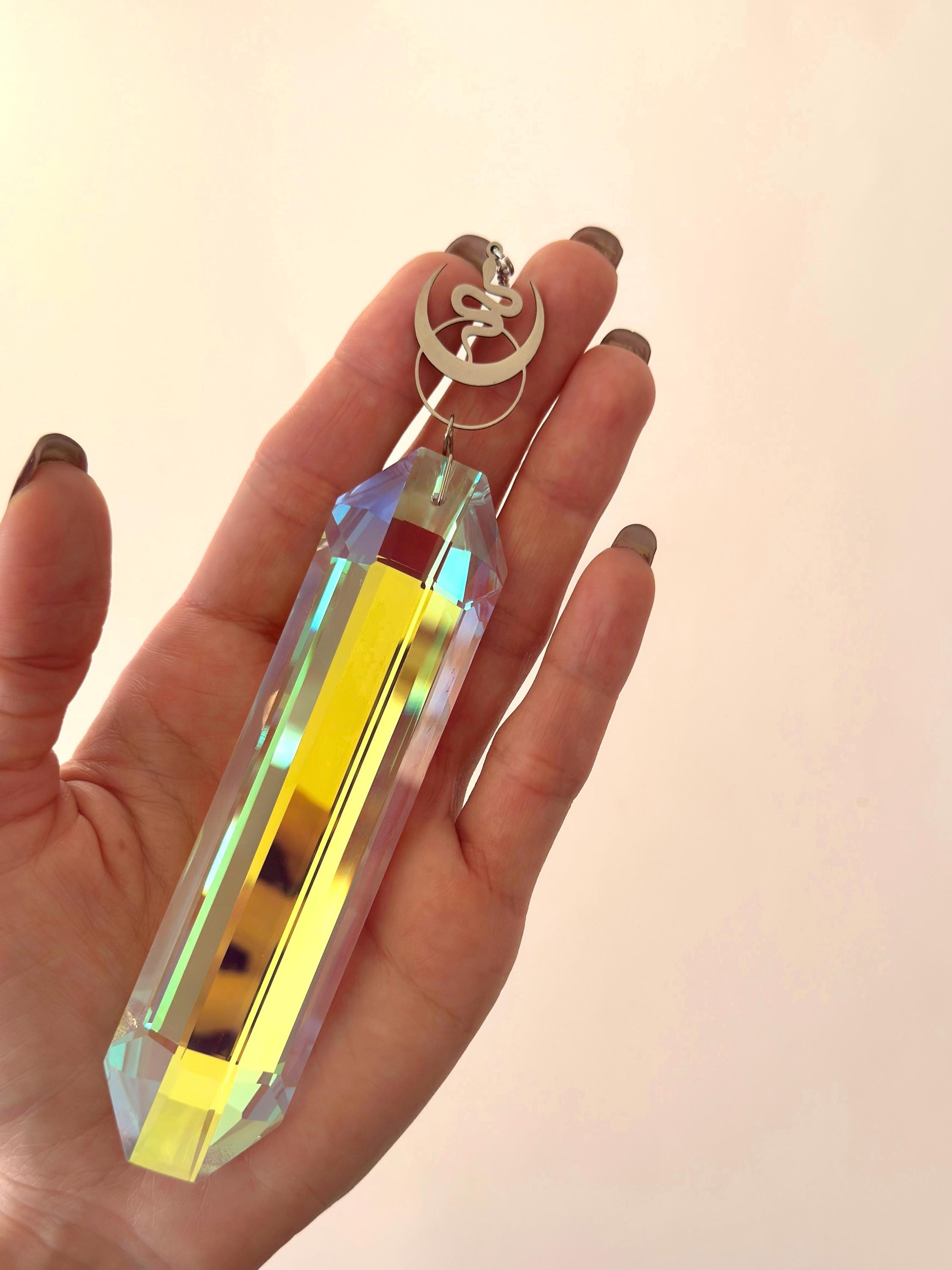 Alchemist's Shadow celestial suncatcher (Sonnenfänger) with a silver snake and moon charm, featuring a 12cm Aurora crystal casting rainbows (Regenbogen).