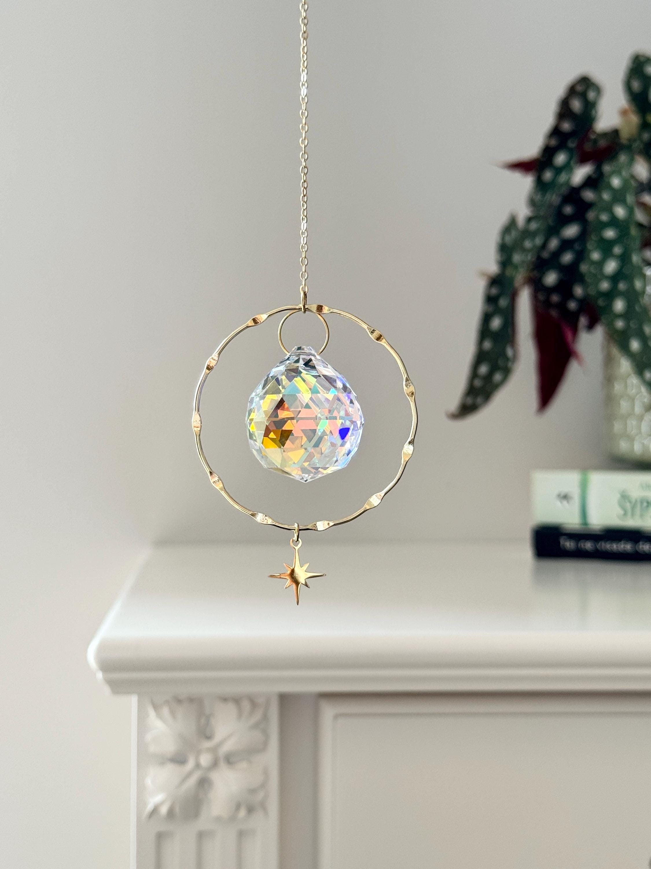 Handcrafted gold-plated suncatcher featuring a 3cm faceted crystal prism and a delicate celestial star charm.