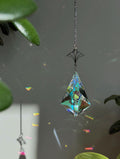 Victorian Fleur suncatcher (Sonnenfänger) with a 7.5cm faceted crystal and elegant silver details, scattering rainbows (Regenbogen) across a sunlit room.